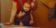 Braxton is registered to the contest to win money with this photo: baby, baby_carrier, bathroom, casual, devil_horns, digital_filter, face, mirror, mirror_reflection, phone, playful, red_shirt, selfie, sink, smile, tattoo, toiletries, tongue_out, towel, woman