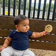 Jude joined the competition — help win amazing prizes! baby, child, bench, outdoor, wood, fence, giraffe, sign, clothing, pants, socks, person, cute, sitting, nature, infant, portrait, curious, casual, daytime