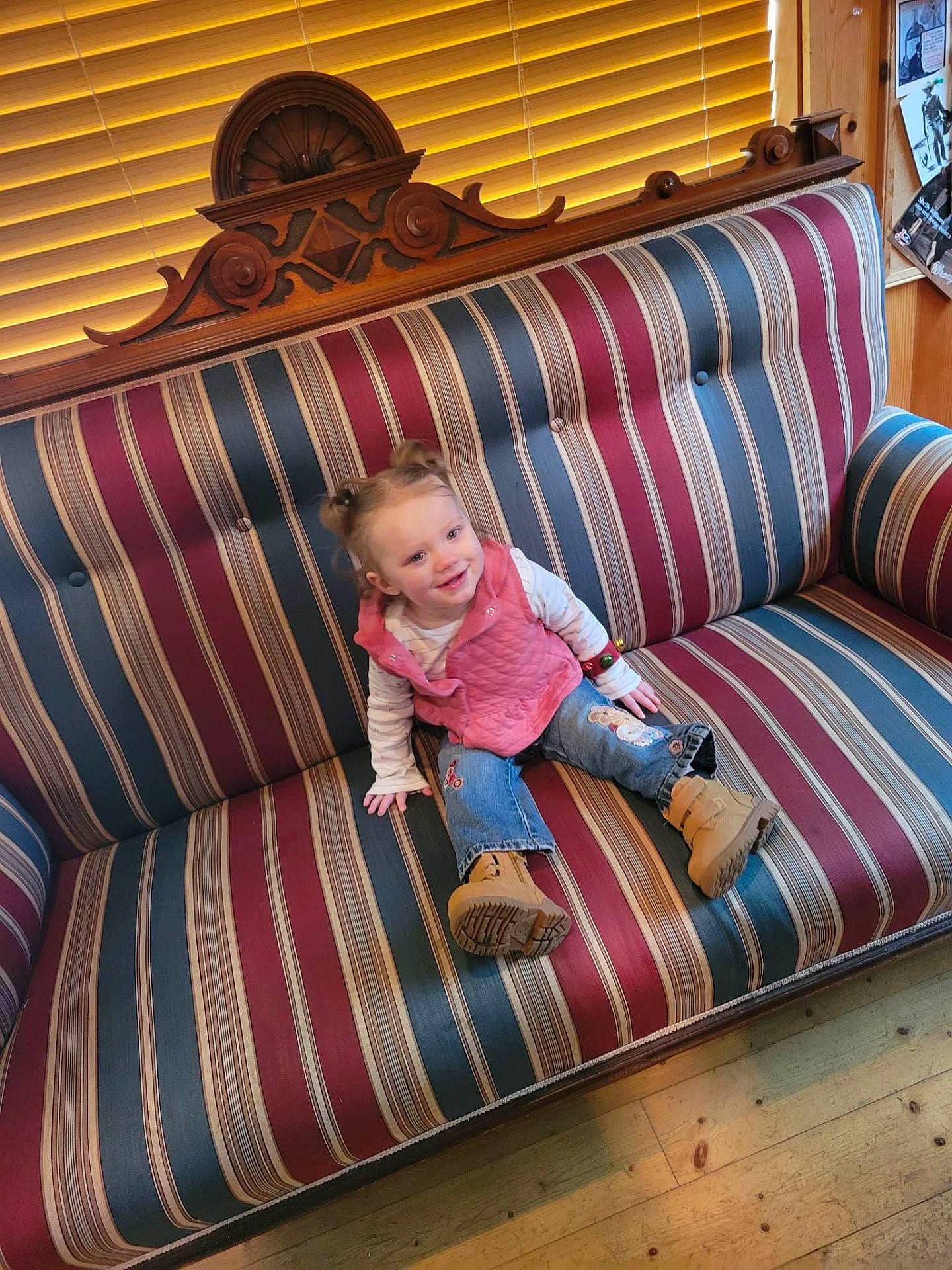Coraline is registered to the contest to win money with this photo: baby, baby_toddler_clothing, child, comfort, couch, floor, flooring, furniture, hardwood, interior_design, joy, linens, living_room, magenta, pattern, person, pillow, rectangle, studio_couch, textile