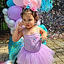 Camila joined the competition — help win amazing prizes! child, girl, tutu, balloons, outdoor, party, mermaid_tail_balloon, headband, pink, lavender, footwear, hello_kitty, pavement, sunlight, decorations, bracelet, necklace, curly_hair, playful, festive