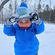 Neiko joined the competition — help win amazing prizes! child, winter_clothing, blue_jacket, knit_hat, gloves, snow, outdoor, forest, trees, playful, happy, cold_weather, smiling, snowflakes, pants, nature, daytime, person, portrait, seasonal
