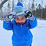 child, winter_clothing, blue_jacket, knit_hat, gloves, snow, outdoor, forest, trees, playful, happy, cold_weather, smiling, snowflakes, pants, nature, daytime, person, portrait, seasonal