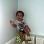 Neiko joined the competition — help win amazing prizes! toddler, child, boy, smiling, sitting, waving, spiderman_shirt, shorts, sneakers, gift_boxes, carpet, corner, wall, indoor, playful, happy, curly_hair, person, casual_clothing, home