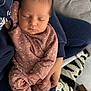 baby, newborn, sleeping, infant, pajamas, polka_dot, hand, blanket, pacifier, cozy, soft_lighting, closeup, person, indoor, rest, cute, peaceful, clothing, child, holding