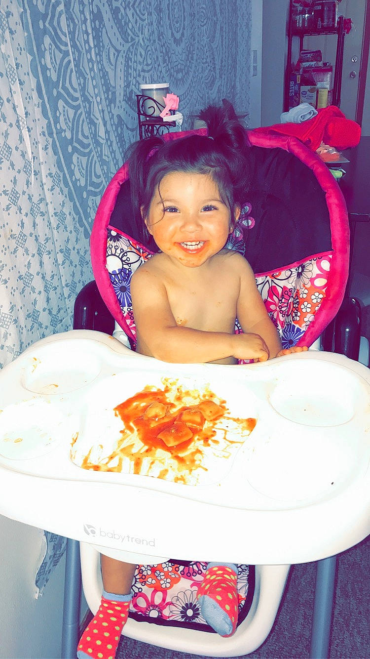 Aya is registered to the contest to win money with this photo: birthday, child, eating, face, food, happy, joy, party, person, pink, sitting, smile, toddler