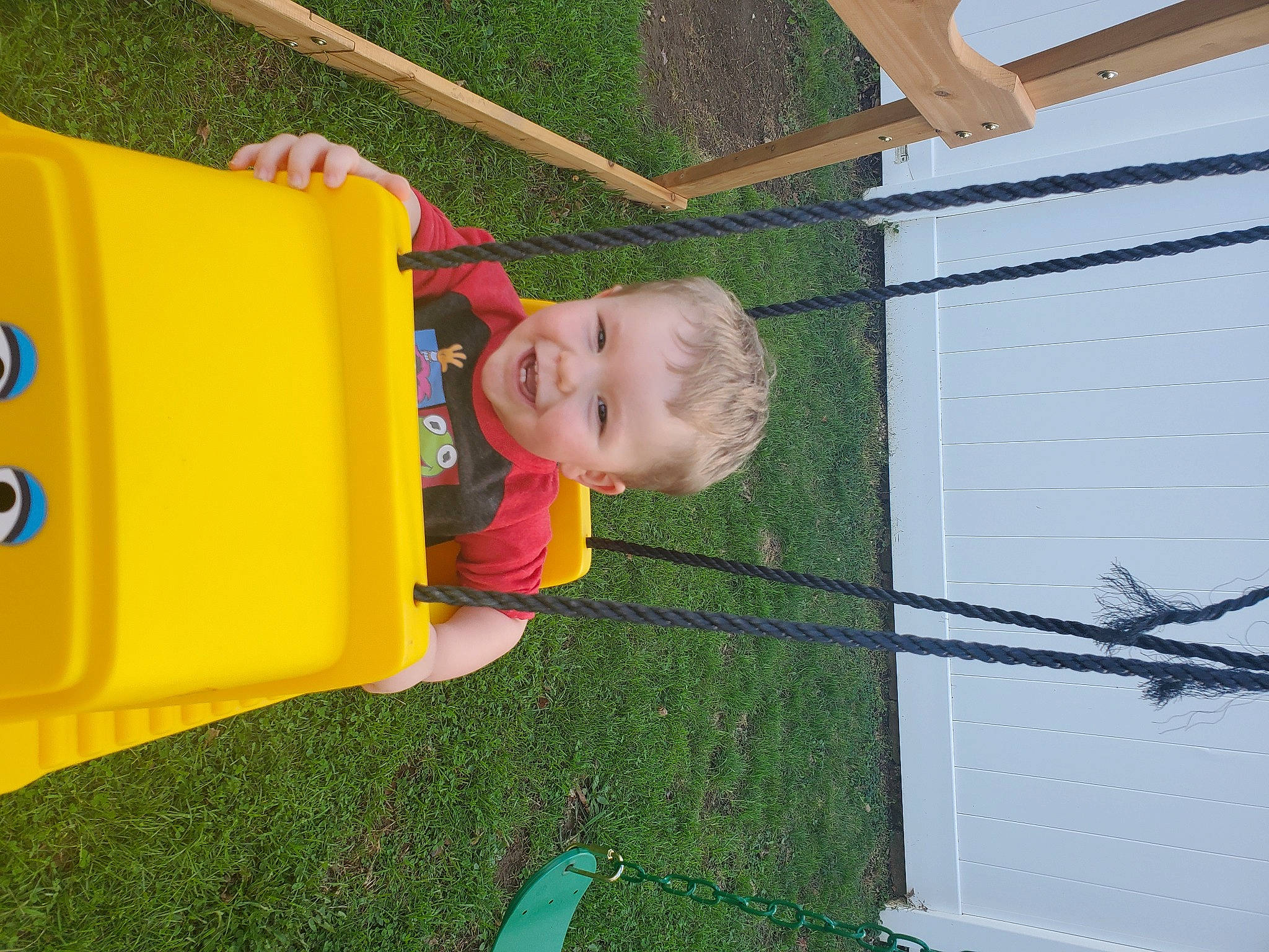 Axl is registered to the contest to win money with this photo: child, chute, city, fence, fun, grass, house, joy, lawn, leisure, mesh, outdoor_play_equipment, person, plant, play, playground, recreation, shade, smile, t_shirt