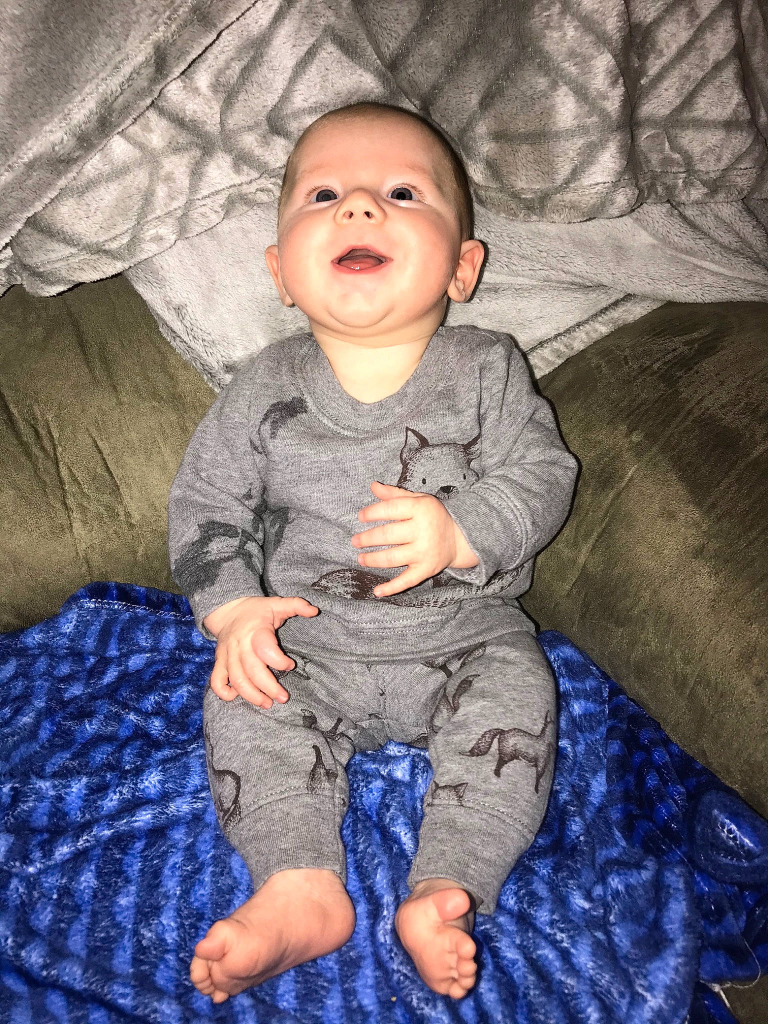 Carson is registered to the contest to win money with this photo: arm, baby, cheek, child, eye, face, head, person, sitting, skin, sleeve, smile, toddler