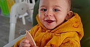 Noham a rejoint le concours — aidez-le/la à gagner de superbes lots ! baby, child, clothing, cozy, cute, face, fireplace, food, furniture, hands, happy, high_chair, indoor, infant, portrait, smiling, snack, toy, warm, yellow_jacket