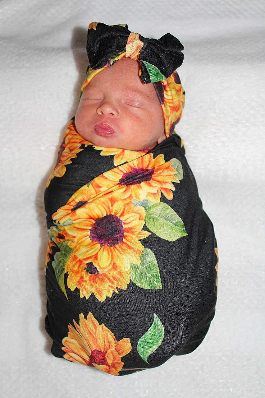 Lelanie joined the competition — help win amazing prizes! newborn, baby, sleeping, swaddle, headband, bow, sunflower, flower_pattern, blanket, cute, infant, wrapped, peaceful, portrait, soft, cozy, child, resting, closed_eyes, adorable