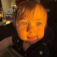 Truett joined the competition — help win amazing prizes! baby, black_shirt, blue_eyes, child, close_up, curious_expression, face, golden_hour, high_chair, household_items, indoor, kitchen_counter, mischievous, person, planet_pattern, portrait, seat, short_hair, toddler, warm_light
