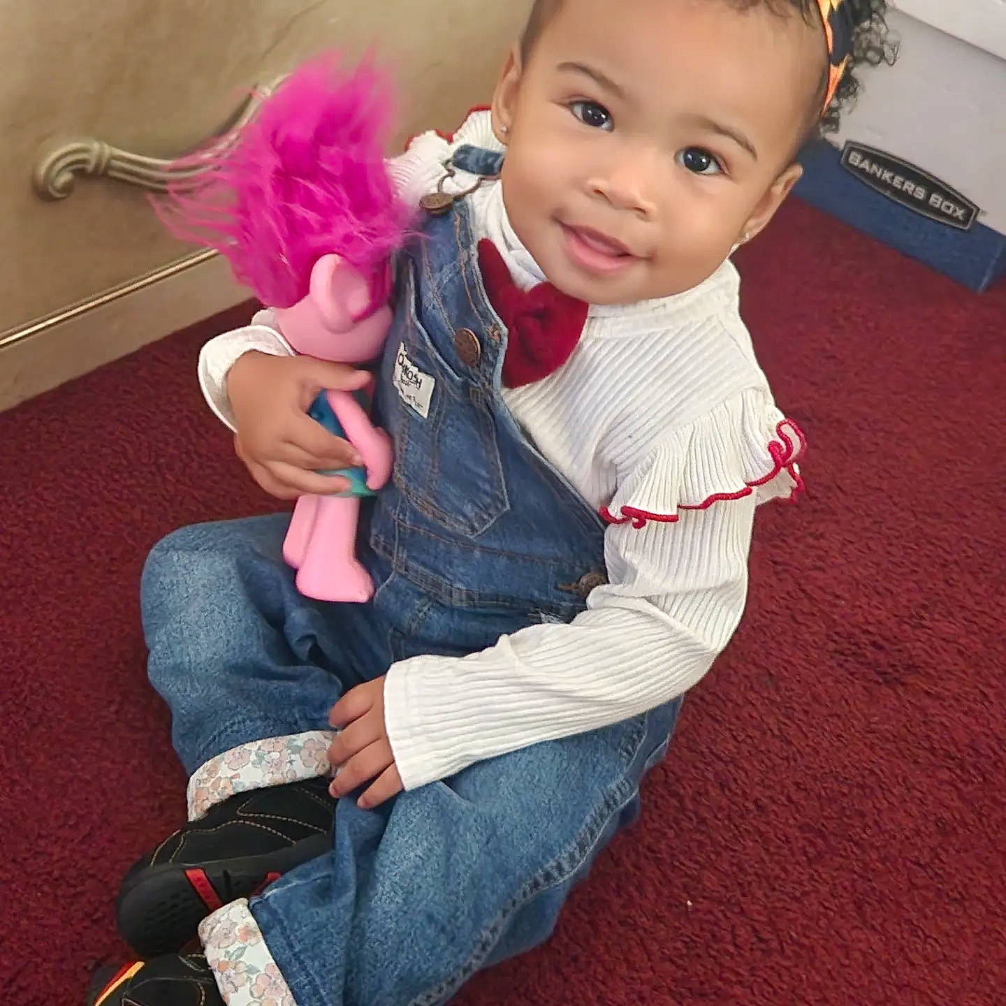 Aadiya is registered to the contest to win money with this photo: baby, baby_toddler_clothing, cheek, child, eye, fashion_accessory, flooring, fun, happy, head, human_leg, leg, magenta, person, sitting, skin, sleeve, sock, stuffed_toy, thumb