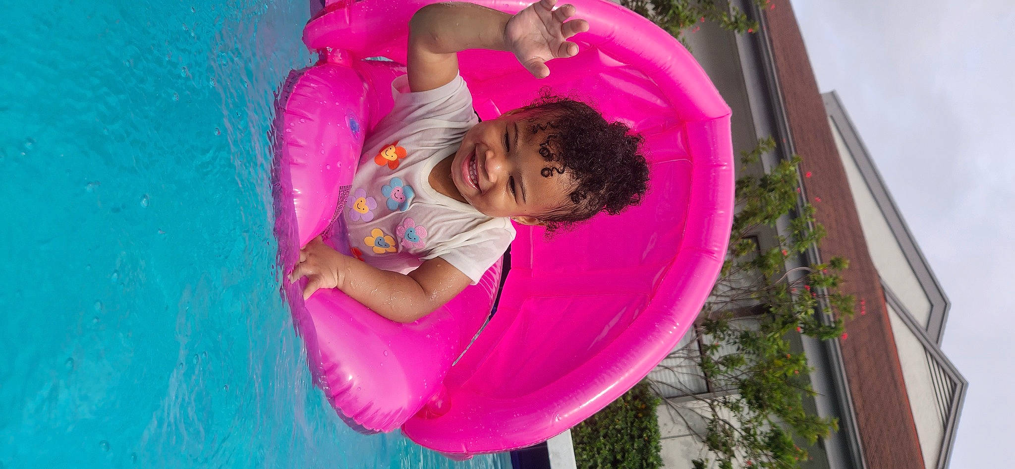 Aadiya is registered to the contest to win money with this photo: bathing, child, circle, fun, grass, happy, joy, leisure, magenta, people_in_nature, person, pink, plant, play, purple, recreation, swimming_pool, toddler, tree, vacation