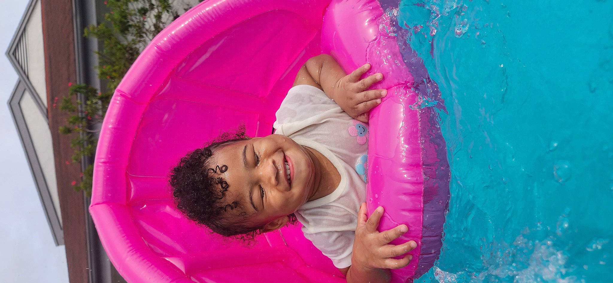 Aadiya is registered to the contest to win money with this photo: child, comfort, fun, grass, happy, joy, leisure, magenta, outdoor_play_equipment, person, pink, play, purple, recreation, red, smile, swimming_pool, toddler, tree, vacation