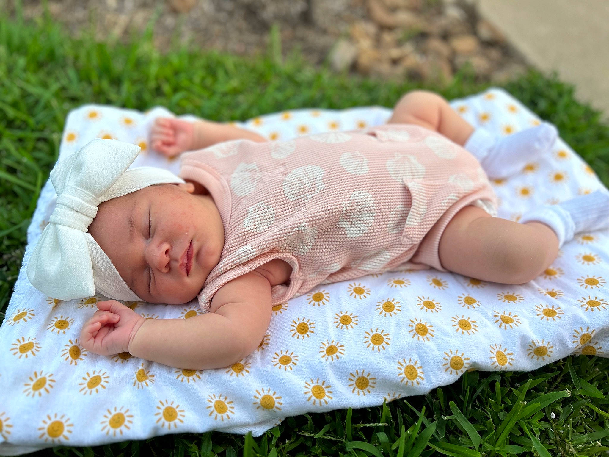 Harper is registered to the contest to win money with this photo: art, baby, baby_toddler_clothing, child, comfort, dress, grass, happy, head, headwear, leaf, linens, pattern, people, people_in_nature, person, sitting, skin, sleeve, textile