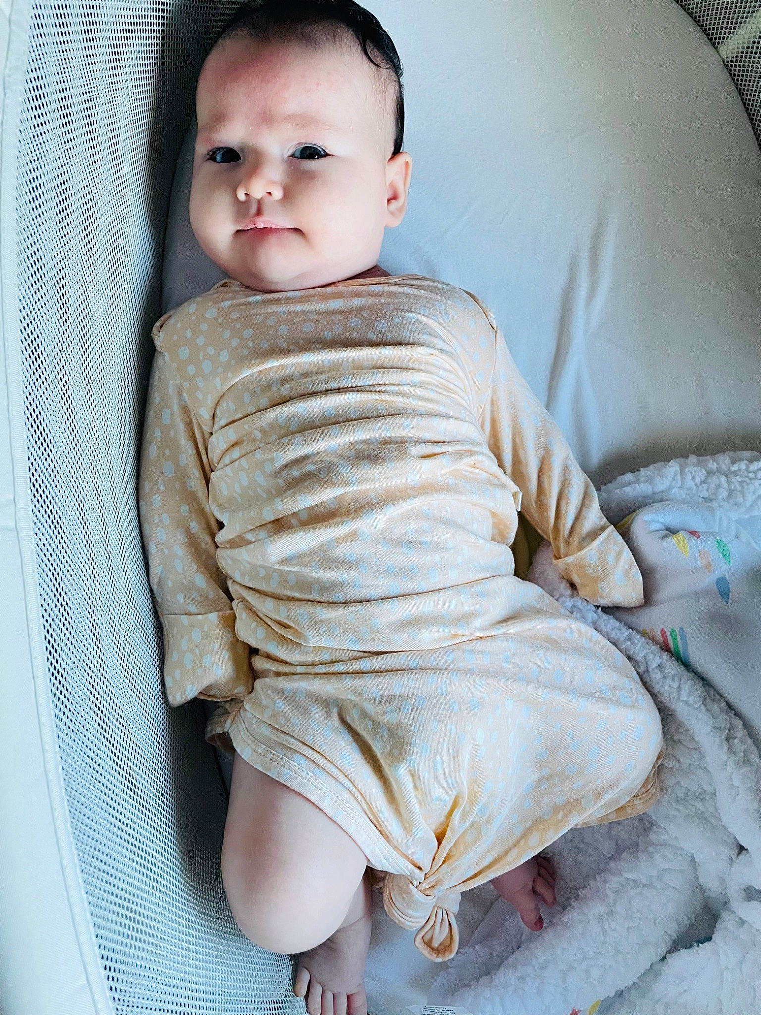 Skylar is registered to the contest to win money with this photo: arm, baby, baby_toddler_clothing, chest, child, collar, comfort, human_leg, knee, leg, linens, neck, pattern, person, shoulder, sitting, skin, sleeve, stomach, thigh