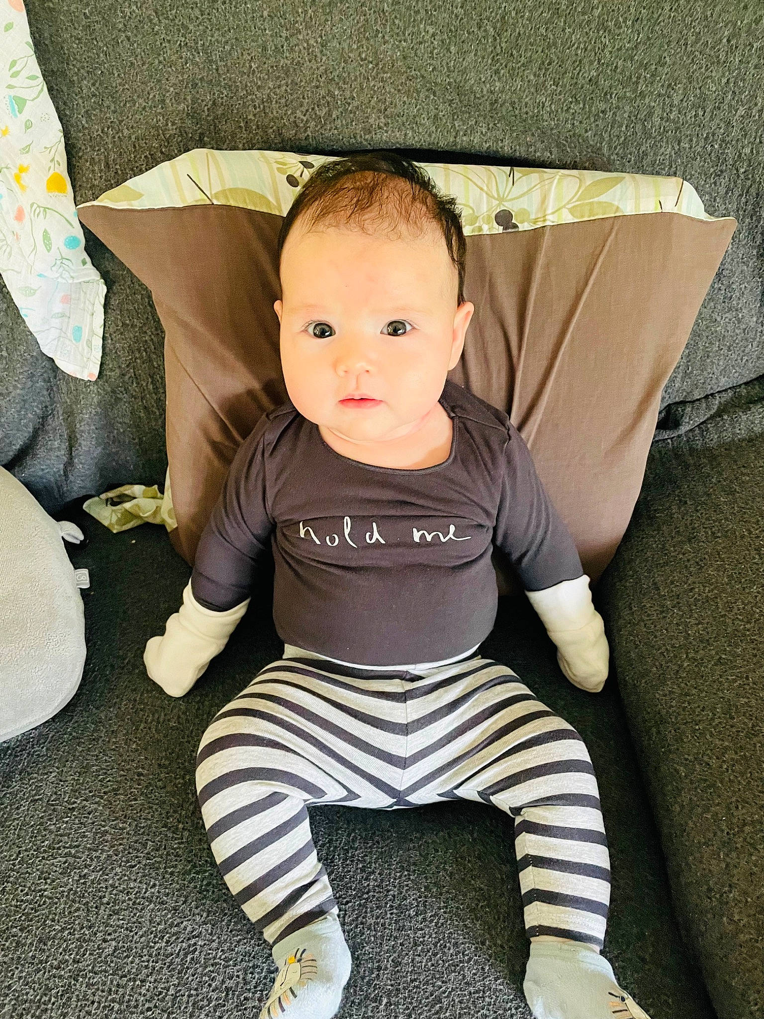 Skylar is registered to the contest to win money with this photo: baby, baby_toddler_clothing, chair, cheek, child, comfort, electric_blue, eye, face, flash_photography, flooring, happy, head, human_leg, knee, person, sitting, sleeve, t_shirt, thigh