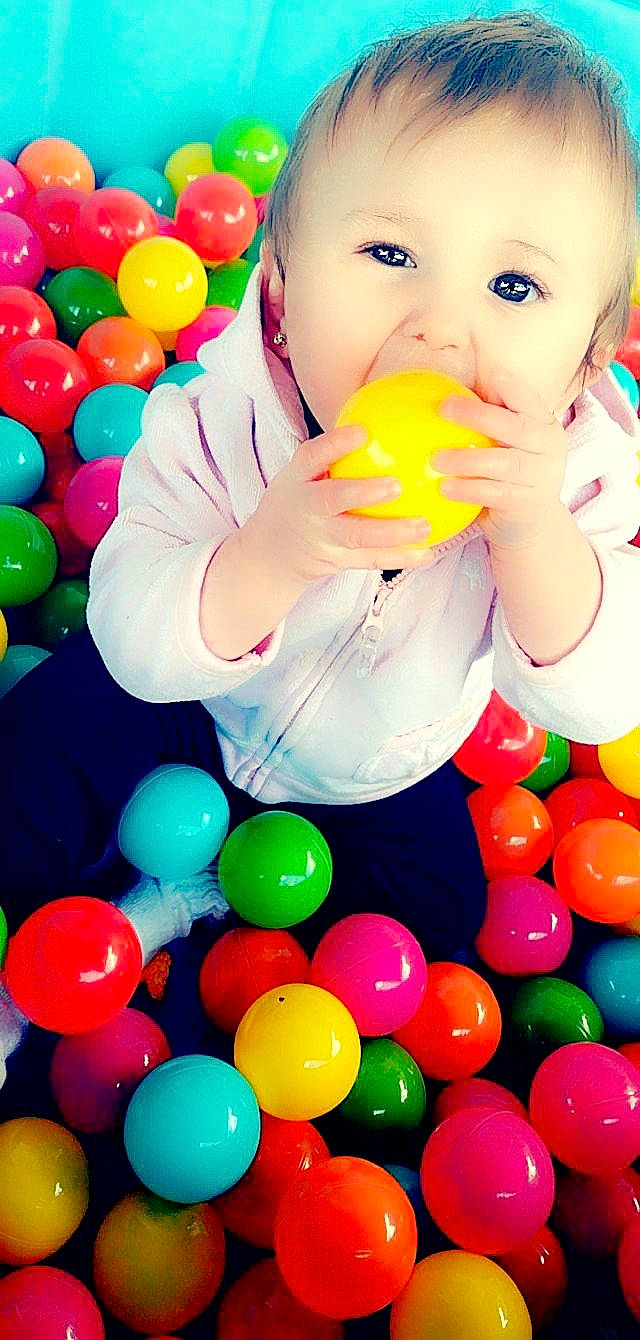 Isabella is registered to the contest to win money with this photo: baby_playing_with_toys, ball_pit, beauty, child, event, facial_expression, fun, green, happy, light, party_supply, people, person, photograph, play, product, snapshot, sweetness, toddler, white