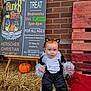 black_and_white, brick_wall, cat_ears, child, costume, cute, event, fall, festival, halloween, hay, holiday, outdoor, person, portrait, pumpkin, red_hair, sign, toddler, wooden_pallet