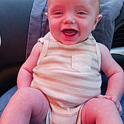 Samuel is registered to the contest to win money with this photo: arm, baby, car_interior, child, daytime, face, happy, head, infant, lap, leg, nature, onesie, outdoor, person, road, sitting, smiling, striped_clothing, window