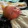 baby, newborn, blanket, winnie_the_pooh, clothing, face, portrait, infant, lying_down, cozy, soft_texture, expression, cute, indoors, child, sleepwear, closeup, person, head, zipped_jacket
