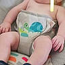 baby, infant, diaper, baby_seat, socks, toy, elephant_toy, cute, chubby, child, indoor, colorful, playful, turtle_design, legs, arms, face, looking_away, comfort, relaxed