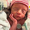 newborn, baby, sleeping, hand, face, hat, striped_hat, blanket, wrapped, infant, skin, peaceful, indoors, closeup, portrait, cute, tiny, resting, person, soft