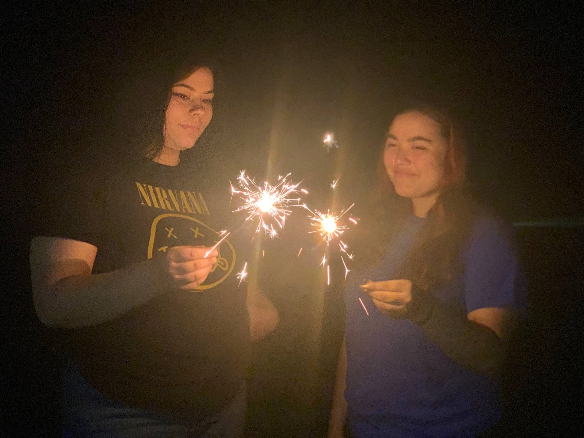 Genesis is registered to the contest to win money with this photo: darkness, event, fun, gesture, joy, lens_flare, light, night, party_supply, person, photography, sky, smile, sparkler