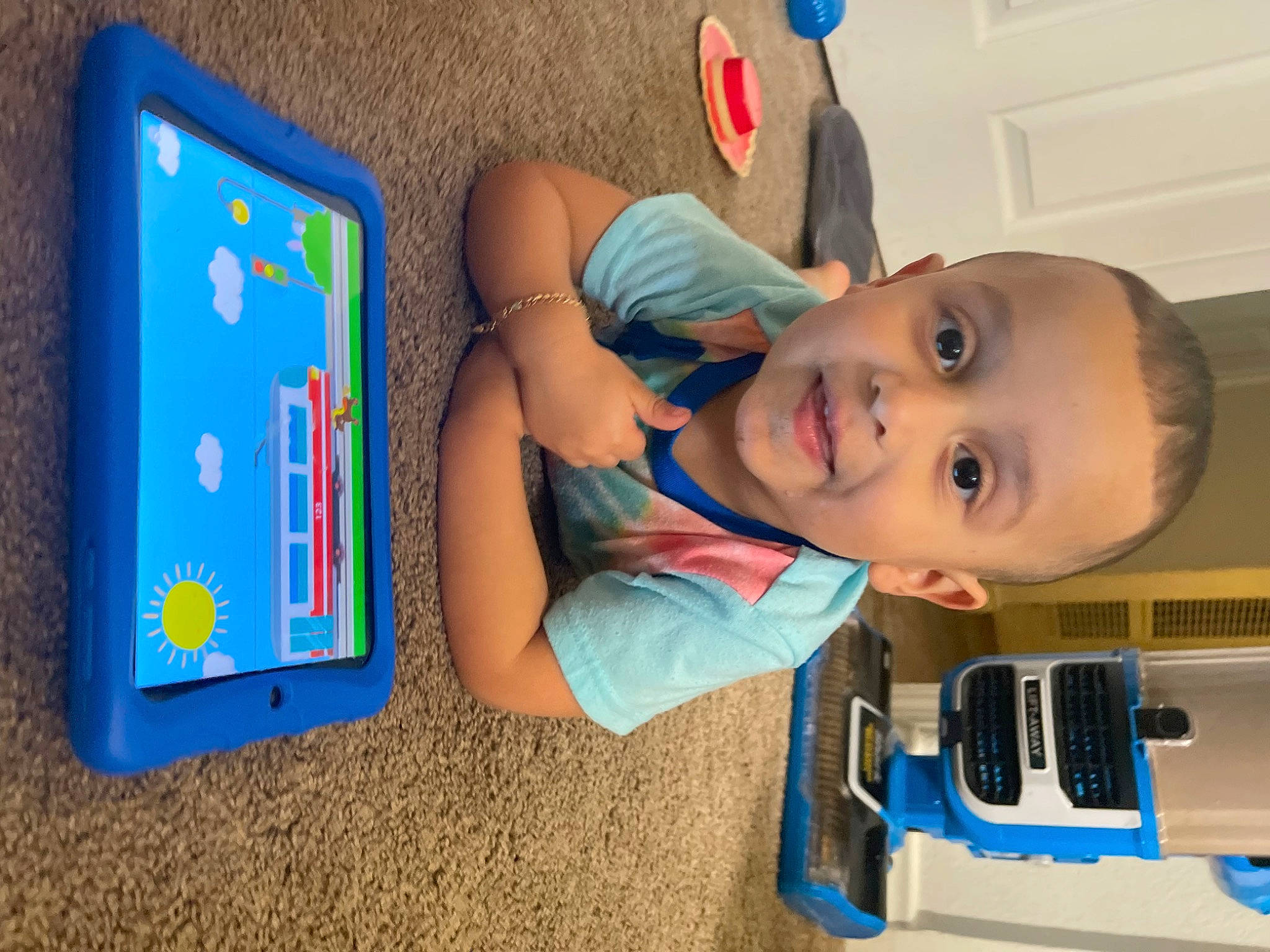 Azriel joined the competition — help win amazing prizes! baby, baby_toddler_clothing, blue, child, computer, electric_blue, finger, flooring, fun, gadget, joy, leisure, person, play, product, rectangle, room, smile, standing, t_shirt