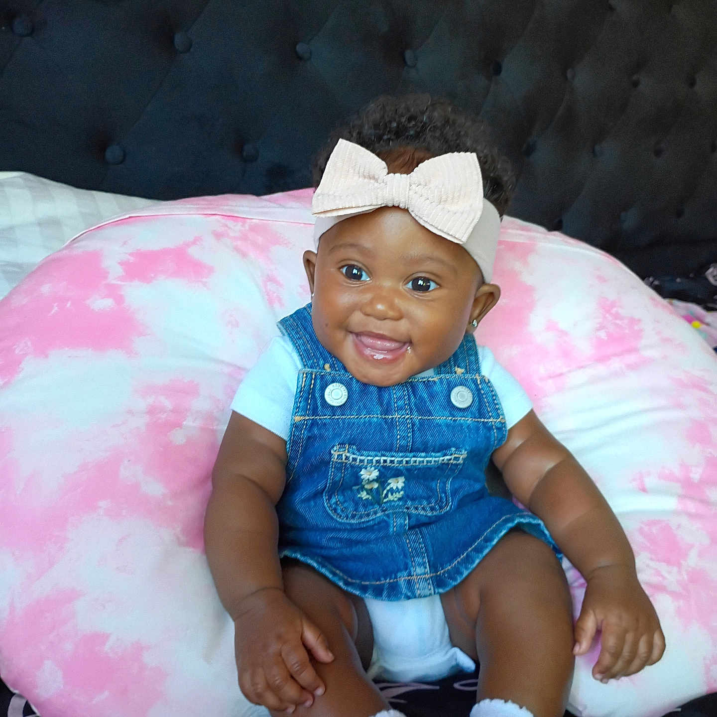 Italy Rose joined the competition — help win amazing prizes! baby, smiling, denim_overalls, headband, bow, cushion, pink, white, tie_dye, sitting, infant, cute, happy, indoors, person, clothing, footwear, sock, face, portrait