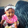 Italy Rose joined the competition — help win amazing prizes! baby, child, smiling, crawling, headband, pink_clothing, heart_pattern, couch, indoor, person, cute, happy, infant, sock, texture, curly_hair, portrait, young_child, bright_eyes, playful