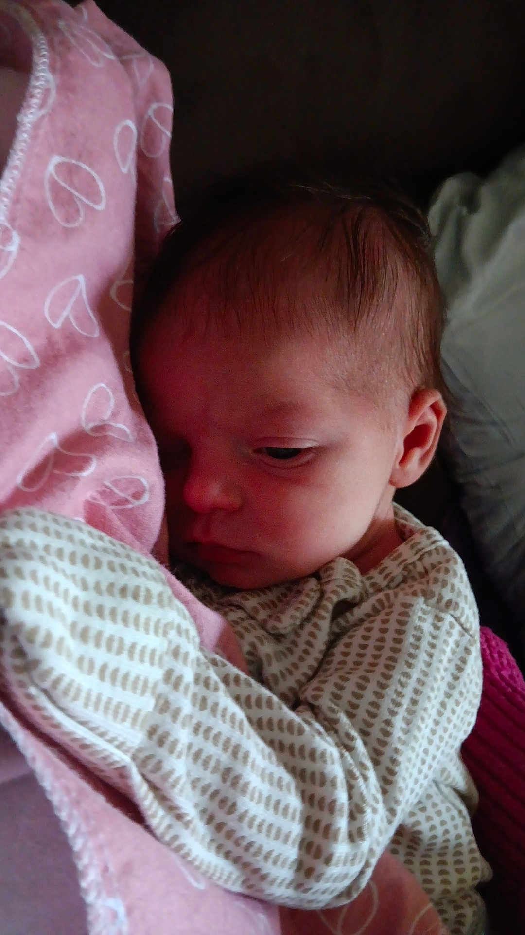 Aliyah is registered to the contest to win money with this photo: baby, blanket, clothing, face, infant, newborn, person, portrait, sleepy, soft, snuggled, warm, young_child, indoors, cozy, pink, patterned_clothing, head, closeup, resting
