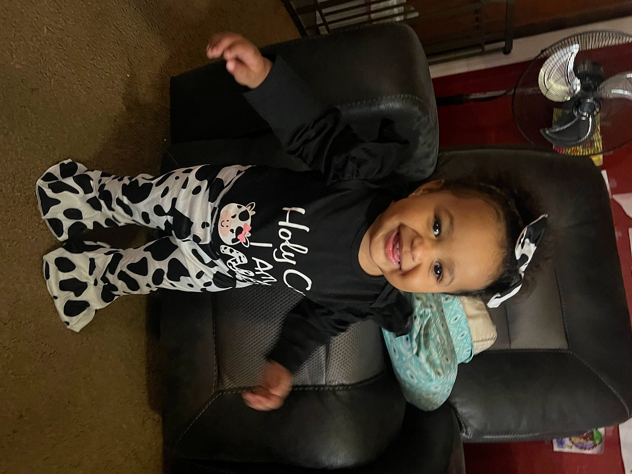 Nevaeh is registered to the contest to win money with this photo: auto_part, black_hair, elbow, flash_photography, fun, joy, person, room, sitting, sleeve, smile, t_shirt, toddler