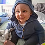 Oliver joined the competition — help win amazing prizes! baby, infant, child, smile, hooded_sweater, knit_hat, blue_sweater, blanket, bed, crib, toes, drool, cheeks, eyes, sitting, indoor, cute, toy, nursery, portrait