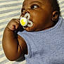 Robert is registered to the contest to win money with this photo: accessories, baby, biting, bodypart, clothing, couch, earring, face, finger, furniture, hand, happy, head, newborn, person, photography, portrait, smile, sphere, t_shirt