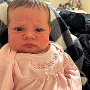 Ainsley is registered to the contest to win money with this photo: baby, infant, face, pink_clothing, blanket, embroidered, portrait, indoor, closeup, child, serious_expression, newborn, soft_lighting, person, cute, young_child, sitting, warm, cozy, fabric