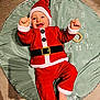 Ayden participe au concours pour gagner de l'argent avec cette photo : baby, infant, child, santa_costume, christmas_hat, smile, play_mat, numbers, months, ring_toy, red_clothing, festive, christmas, lying_down, hands_up, bare_foot, portrait, indoors, happy, milestone_mat
