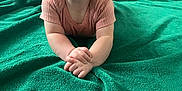 Nova is registered to the contest to win money with this photo: baby, blanket, child, clothing, couch, cute, eyes, face, floor, green_blanket, hands, happy, indoor, infant, person, portrait, short_sleeve, skin, smile, toddler