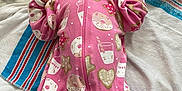 Nova is registered to the contest to win money with this photo: newborn, baby, sleeping, pink_onesie, milk_bottle_pattern, cookie_pattern, star_pattern, bed, blanket, soft_texture, infant, child, cute, cozy, lying_down, peaceful, indoors, fabric, clothing, portrait