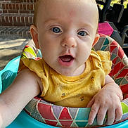 Nova is registered to the contest to win money with this photo: baby, baby_walker, blue_eyes, child, closeup, clothing, colorful, curious, expression, face, hand, head, indoor_outdoor, infant, person, portrait, seat, skin, yellow_shirt, young_child