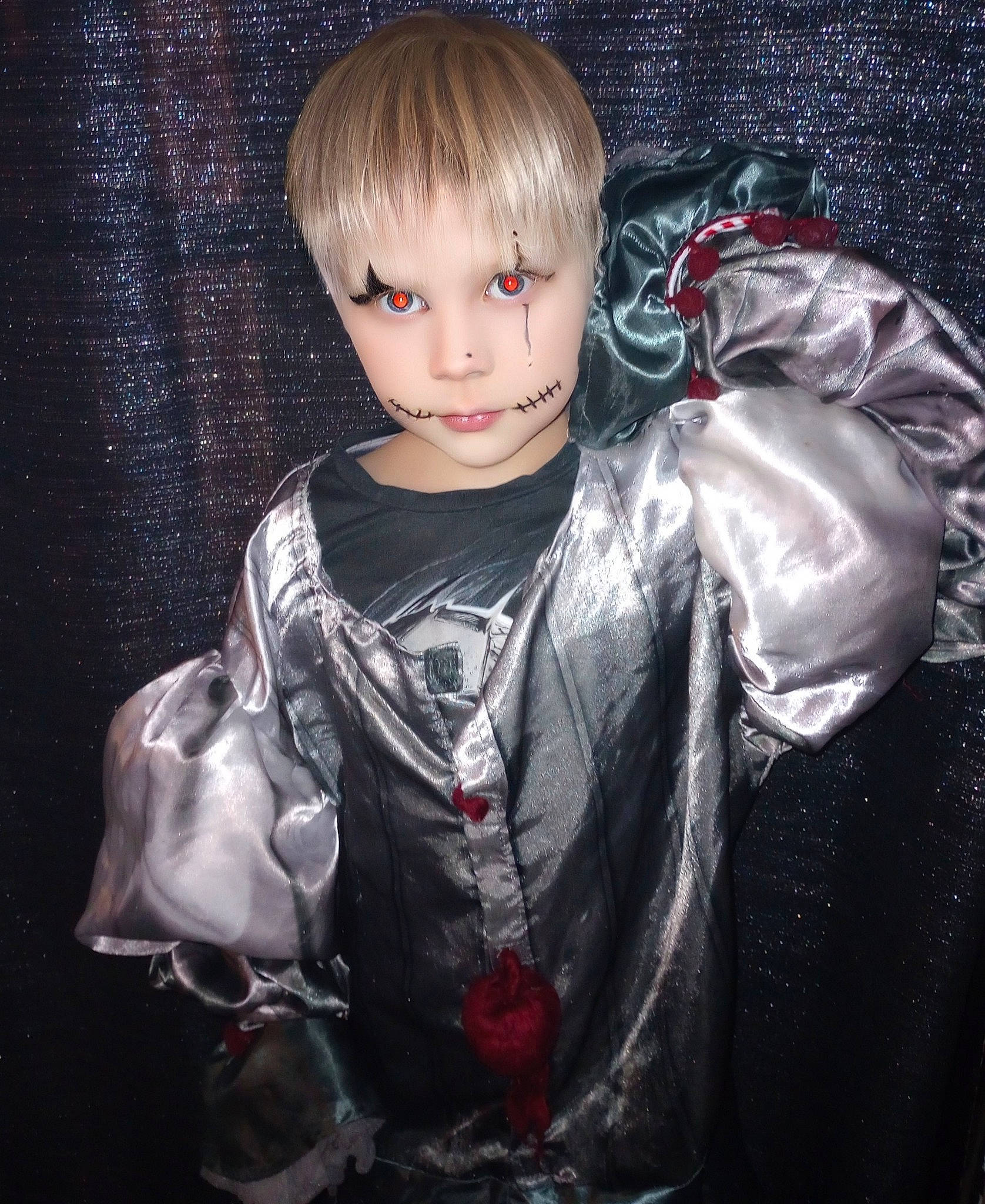 Marcellus is registered to the contest to win money with this photo: action_figure, bangs, blond, child, costume, darkness, doll, eyelash, fashion_design, fictional_character, flash_photography, fur, head, iris, person, satin, sitting, sleeve, toddler, toy