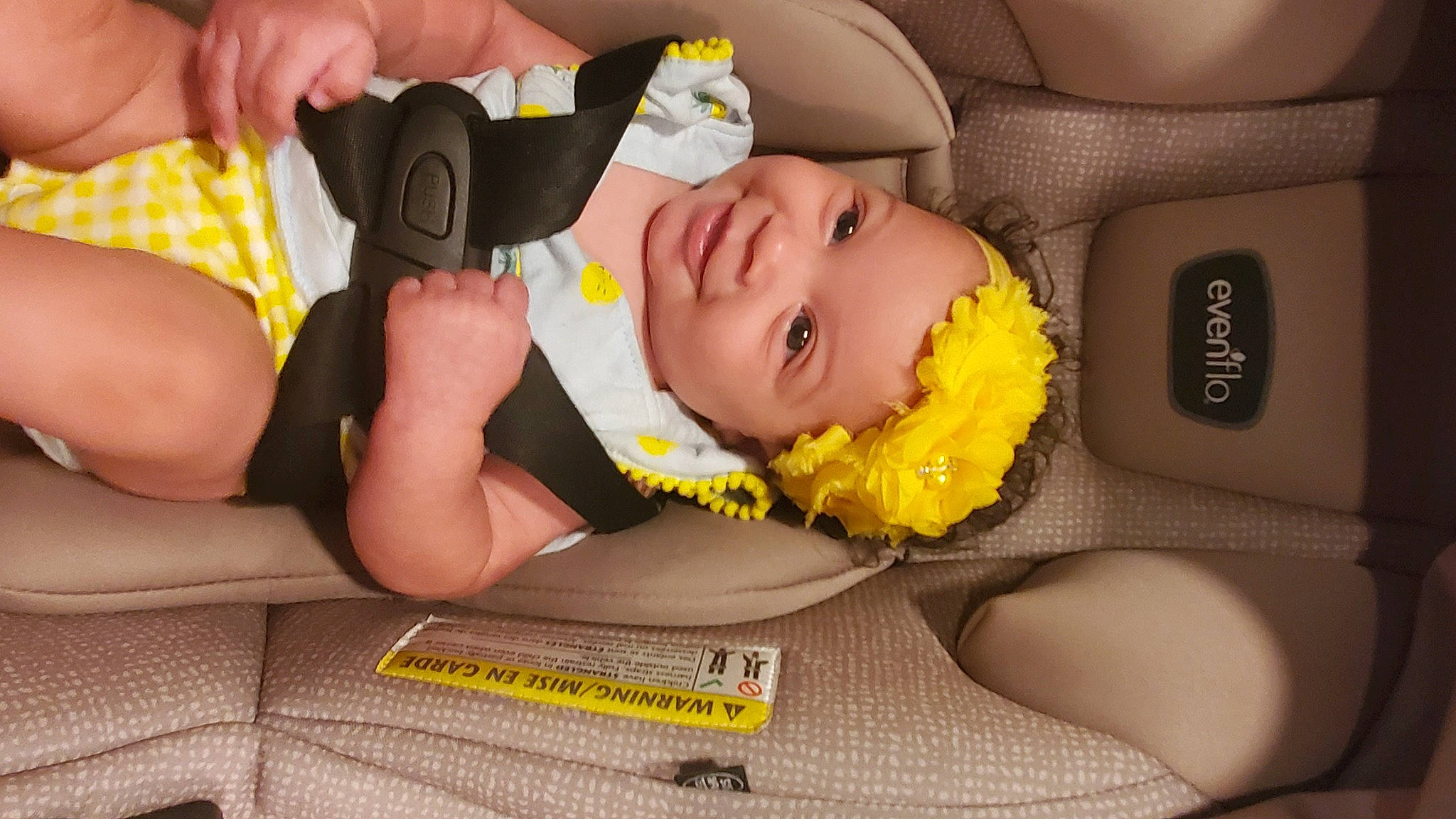 Sorraya is registered to the contest to win money with this photo: arm, baby, baby_products, baby_toddler_clothing, car_seat, child, comfort, facial_expression, finger, flooring, fun, headwear, joy, mouth, nail, person, room, sitting, skin, thigh