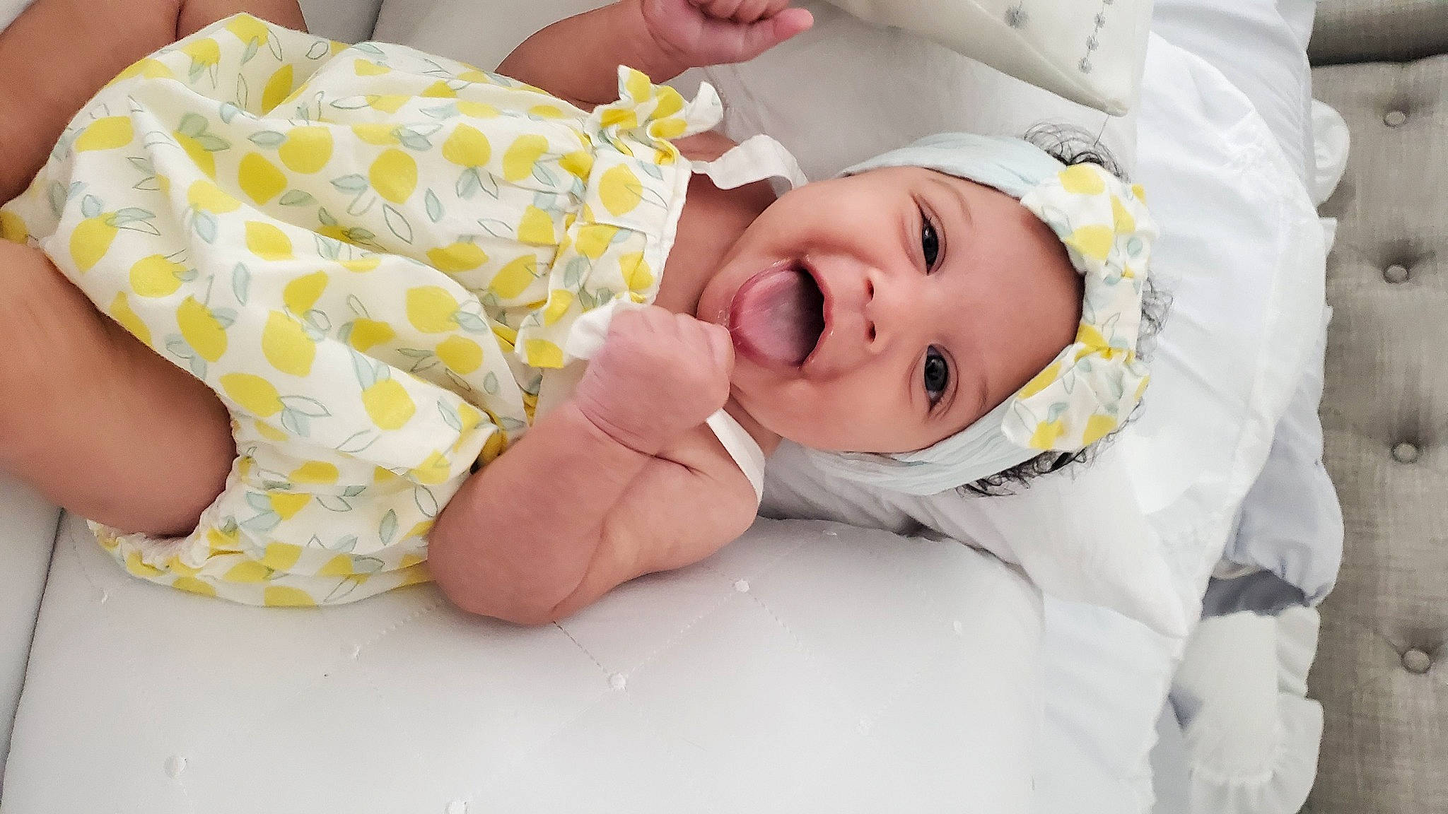 Sorraya is registered to the contest to win money with this photo: baby, baby_products, baby_toddler_clothing, cheek, child, comfort, dress, event, eye, happy, hat, headwear, human_body, linens, pattern, person, portrait_photography, room, skin, sleeve