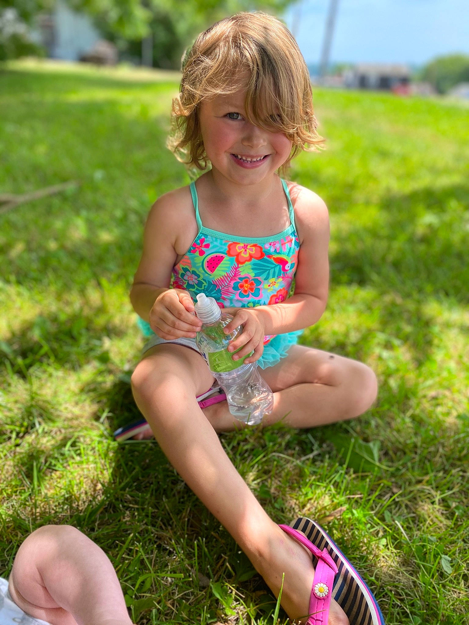 Kendall is registered to the contest to win money with this photo: child, fun, grass, grass_family, green, hand, joy, leg, meadow, person, plant, play, sitting, smile, summer, toddler, vacation