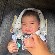 Soujah-Flint joined the competition — help win amazing prizes! baby, car_seat, infant, smile, hand, pacifier, child, safety_harness, clothing, person, cute, portrait, indoor, holding_hand, seat_belt, head_support, happy, toddler, skin, face