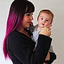 Amélia participe au concours pour gagner de l'argent avec cette photo : woman, baby, child, holding, portrait, indoor, person, long_hair, purple_hair, makeup, face, looking, gray_clothing, skin, expression, love, tenderness, mother, infant, casual