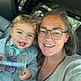 toddler, child, woman, glasses, smile, car_interior, seat, window, sunlight, clothing, hair, blue_eyes, plastic_cup, happy, portrait, casual, family, closeup, person, indoor