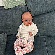 Mady participe au concours pour gagner de l'argent avec cette photo : baby, child, comfortable, couch, cozy, cushion, cute, furniture, gray_couch, happy, home, indoor, infant, patterned_pants, pink_sock, portrait, sitting, smiling, white_top, young_child