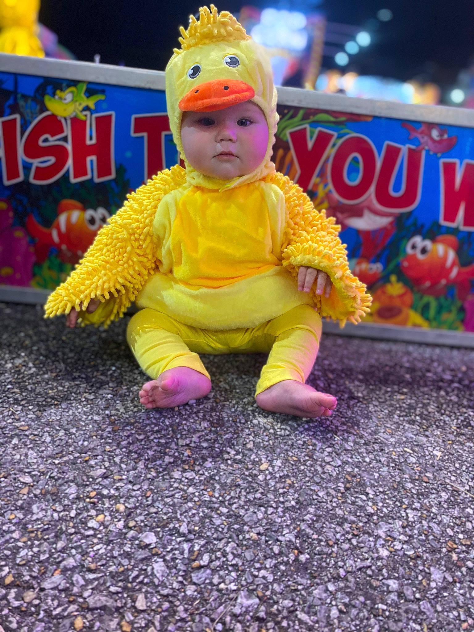 Melody is registered to the contest to win money with this photo: asphalt, baby, baby_toddler_clothing, beanie, cap, child, event, flooring, fun, grass, happy, headwear, leisure, magenta, person, play, purple, recreation, road_surface, sitting