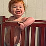 toddler, child, crib, red_hair, diaper, smile, indoor, wooden_crib, baby, happy, grip, face, arm, skin, wall, furniture, playful, cute, person, infant