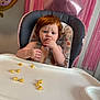 Georgia joined the competition — help win amazing prizes! toddler, high_chair, snack, red_hair, baby, face, hand, blue_eyes, expression, party, balloon, pink, background, table, food, indoor, child, seat, curious, cute